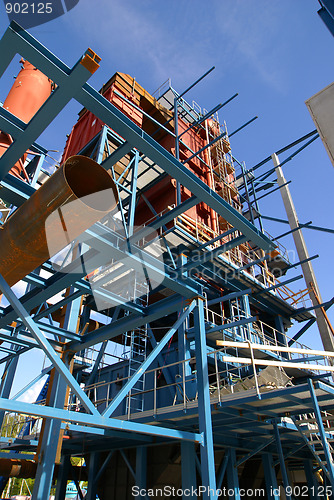 Image of cranes and beams on construction of industrial factory 