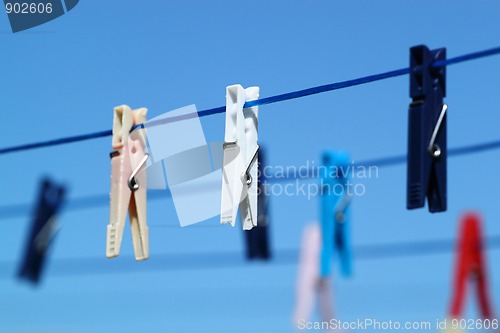 Image of cloth pegs with a under the blue sky 