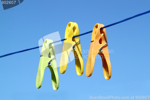 Image of cloth pegs with a under the blue sky