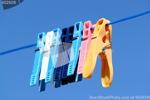 Image of cloth pegs with a under the blue sky