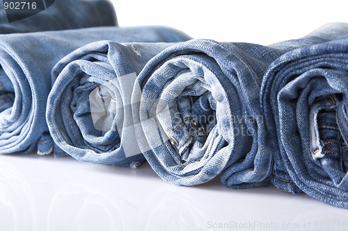 Image of roll blue denim jeans arranged in line