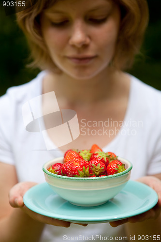 Image of Girl holding a bowl of strawberries