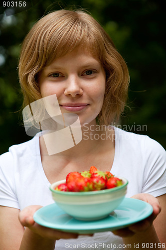 Image of Girl holding a bowl of strawberries