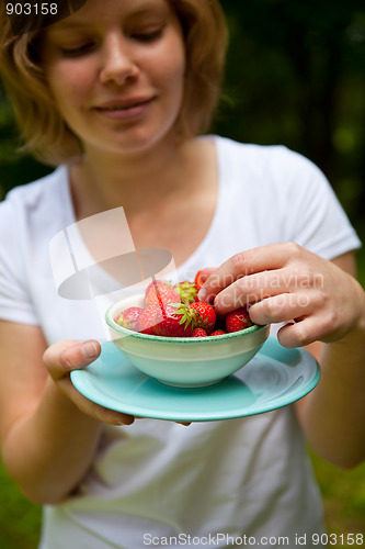 Image of Girl holding a bowl of strawberries