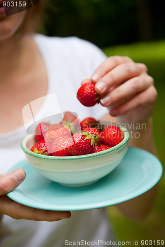 Image of Girl holding a bowl of strawberries