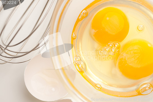 Image of Hand Mixer with Eggs in Glass Bowl