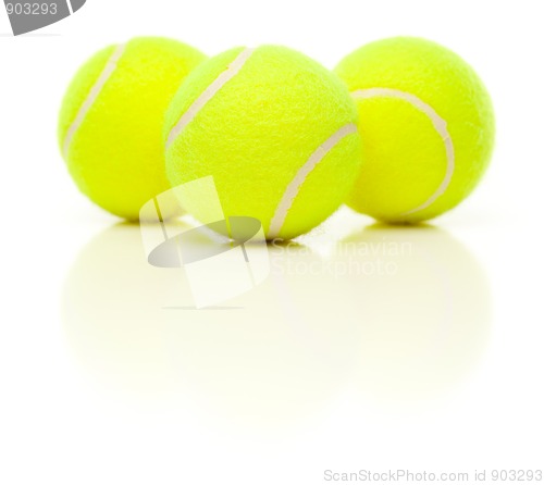 Image of Three Tennis Balls on White with Slight Reflection