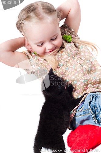 Image of Little girl playing with kitten