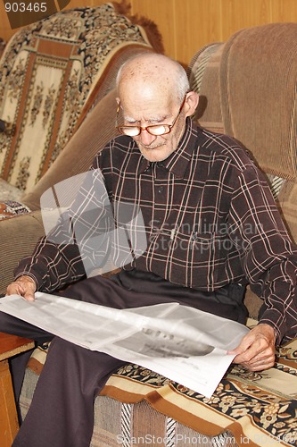 Image of Senior man reading newspaper