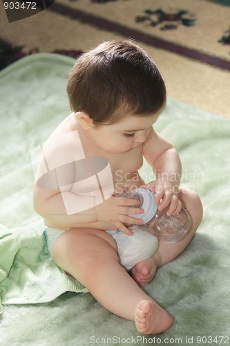 Image of Baby sitting with bottle