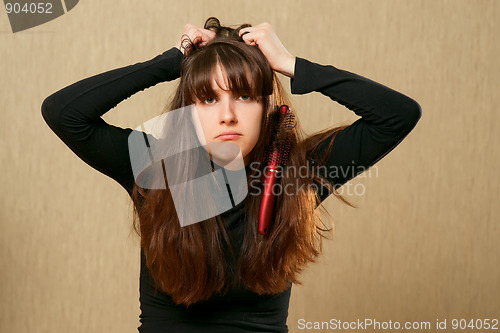 Image of Hairbrush stucks in female hair