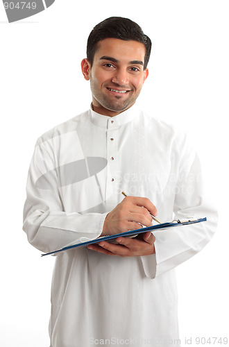 Image of Smiling businessman writing in folder