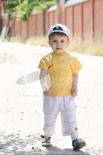 Image of Little boy walking outdoors