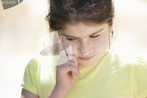 Image of Sad brunette girl in yellow shirt