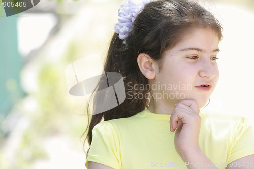 Image of Pensive brunette girl in yellow shirt