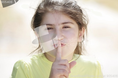 Image of Brunette girl gesturing hush