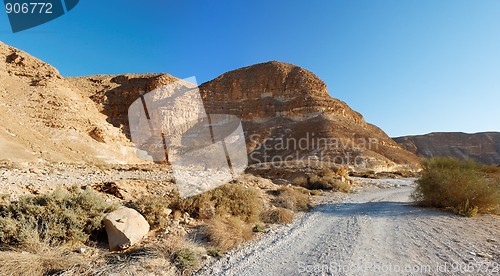 Image of Desert landscape with mountains and road at sunset  