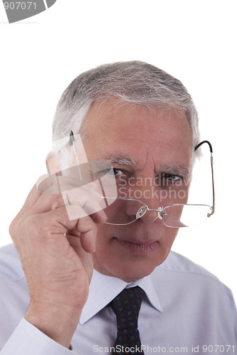 Image of Portrait of a mature  businessman,putting the glasses