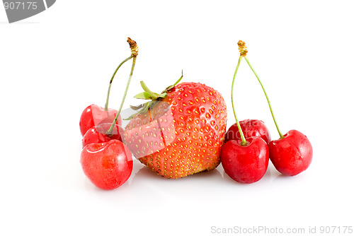 Image of Single tasty red strawberry and some juicy red cherries