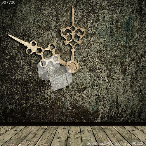 Image of grunge interior and golden clock hands