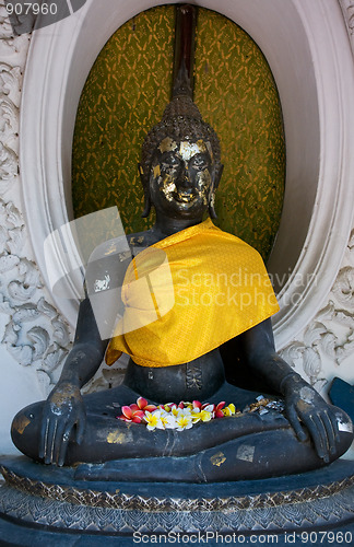 Image of Buddha image with flowers in Nakhon Pathom, Thailand.