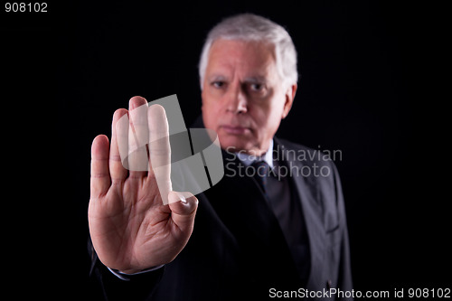 Image of old businessman  with his hand raised in signal to stop