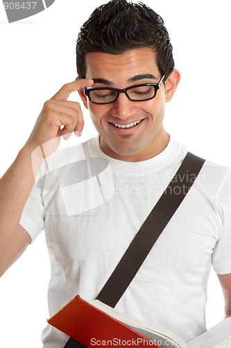 Image of Smiling man reading a texbook