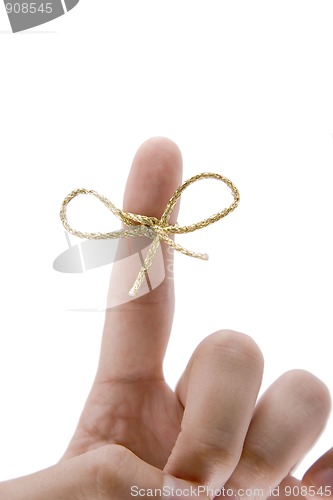 Image of remember concept,  finger with gold tie