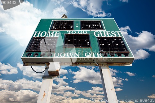 Image of HIgh School Scoreboard Over Blue Sky with Clouds