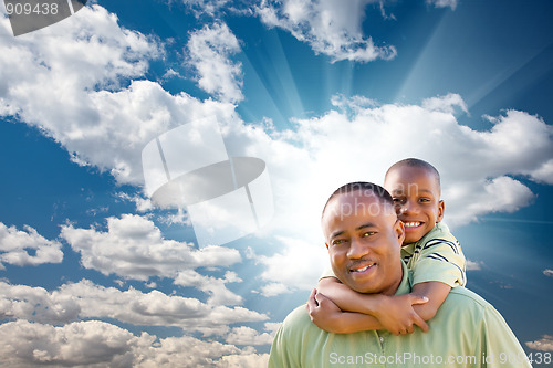 Image of Happy African American Man with Child Over Clouds and Sky