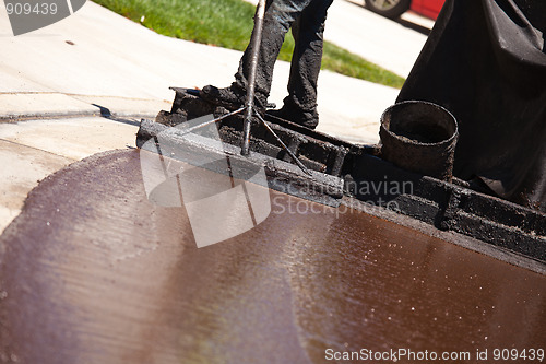 Image of Road Worker Resurfacing Street