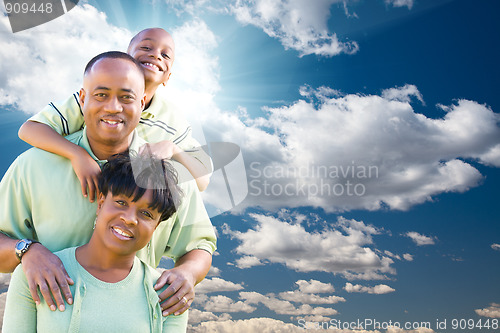 Image of Happy African American Family Over Blue Sky and Clouds