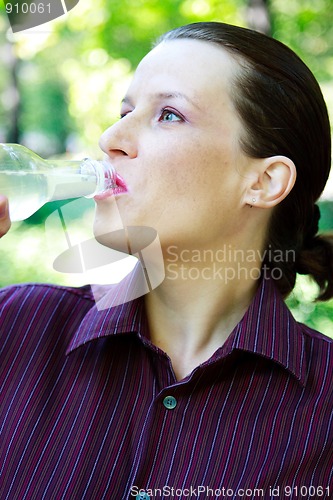 Image of Beautiful young woman drinking