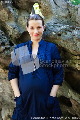 Image of Beautiful young pregnant woman smiling