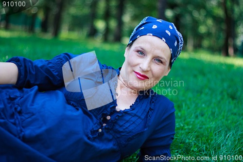 Image of Beautiful young pregnant woman in nature couched