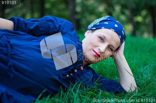 Image of Beautiful young pregnant woman in nature couched