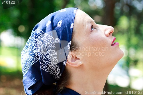 Image of Beautiful young woman looking up