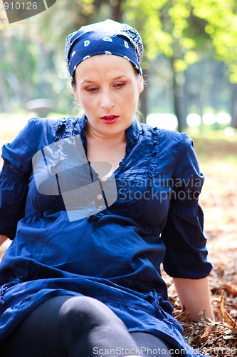 Image of Beautiful young pregnant woman in nature