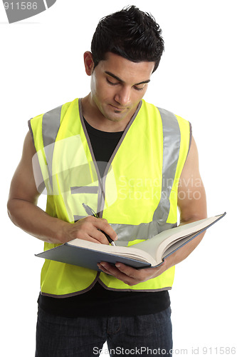 Image of Builder writing in a book