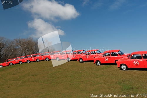 Image of red cars  in row