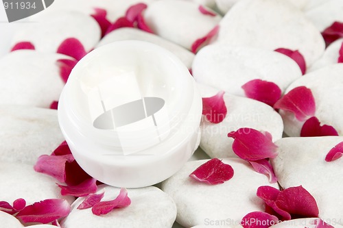 Image of stones and red rose petals background for beauty cream