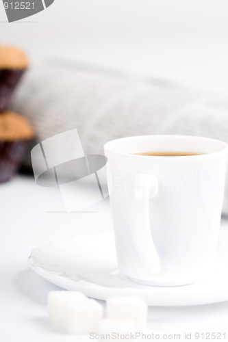 Image of coffee, sugar, muffins and newspapers