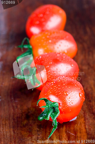 Image of four wet tomatoes