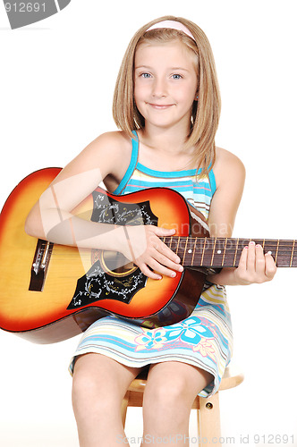 Image of Young blond girl with guitar.