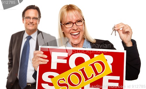 Image of Man with Blonde Woman Holding Keys and Sold For Sale Sign