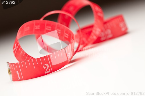 Image of Red Measuring Tape on Gradated Background