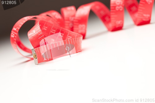 Image of Red Measuring Tape on Gradated Background