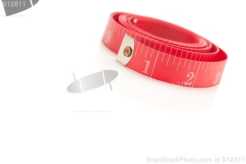 Image of Coiled Red Measuring Tape on White