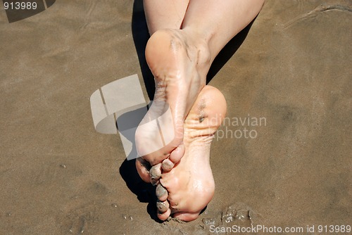 Image of Crossed feet in sand