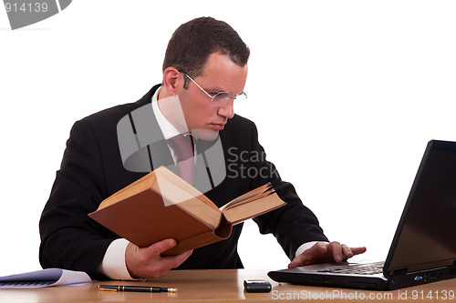 Image of man on desk reading and studying